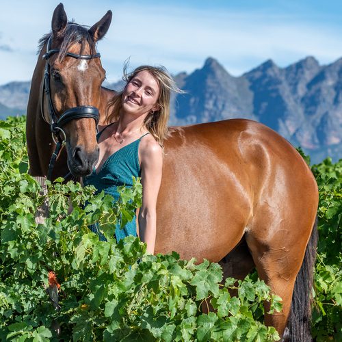 Lady with horse in vineyard